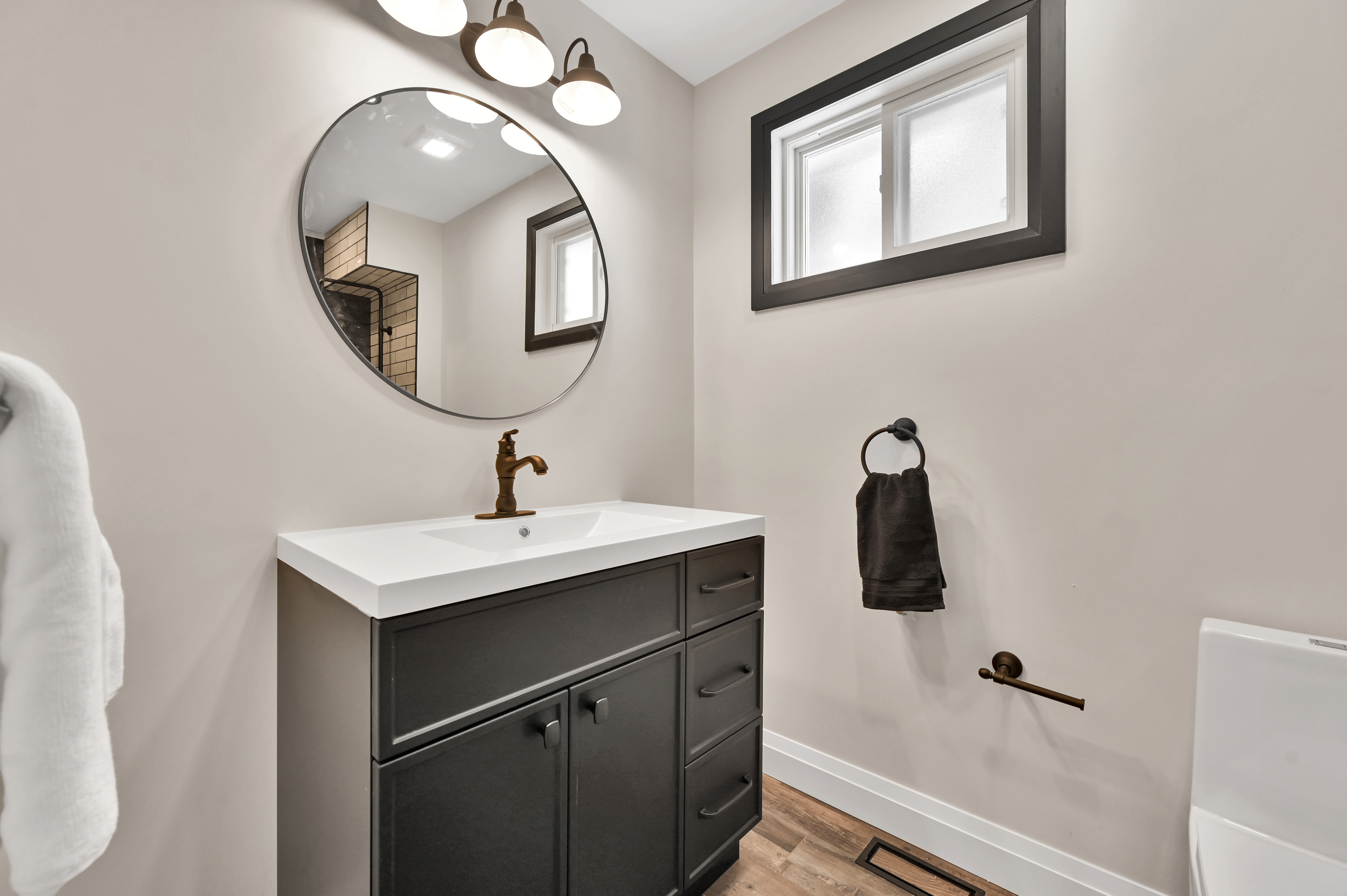 Beautifully finished powder room with modern fixtures, excellent lighting, and professional staging quality — Kron, Hamilton | MTC Renovations